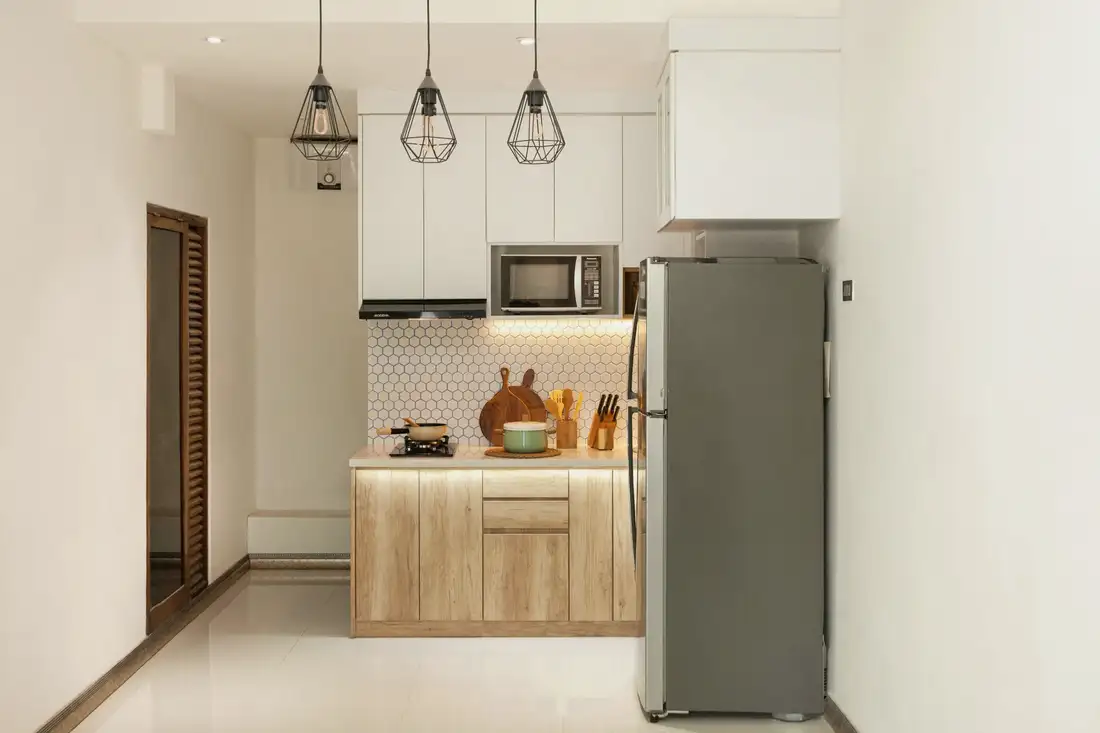 Compact kitchen with appliances and wood shelving